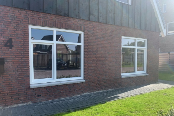 Twee grote kunststof kozijnen in een moderne woning met rode bakstenen gevel